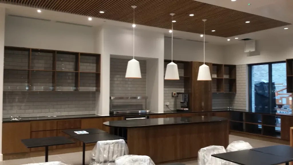Finished hospitality kitchen with pendant and recessed lighting