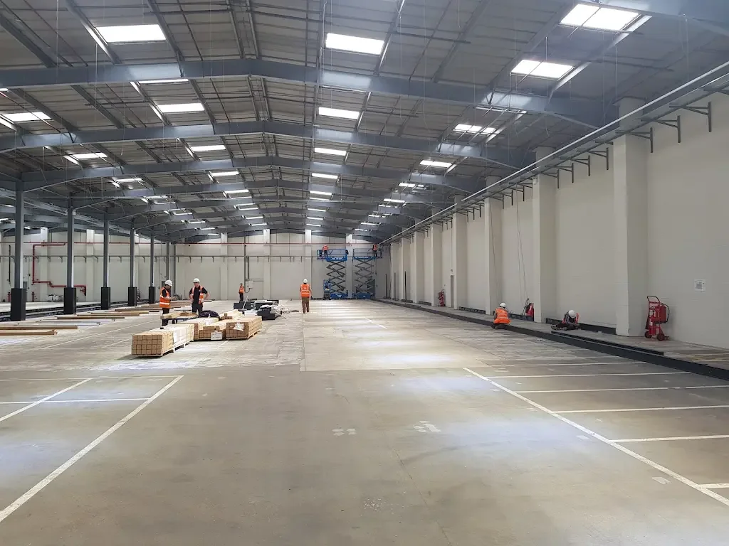 Completed warehouse floor with rows of high-level lighting